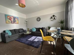 a living room with a couch and a table and chairs at City Hideaway, Entire House in Hull