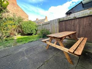 a wooden picnic table sitting on a patio at City Hideaway, Entire House in Hull