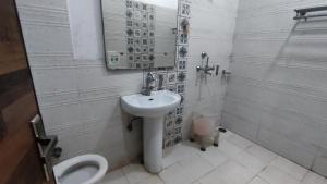 a bathroom with a sink and a toilet at Swastik Vatika in Ambāla