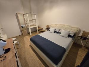 - une chambre avec un grand lit et une couverture bleue dans l'établissement Tre Lati b&b, à Case del Bevano
