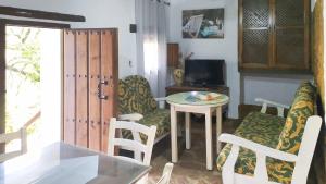 A television and/or entertainment centre at Molino Los Justos - Casa Vieja- Algarinejo by Ruralidays