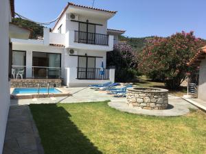 a house with a yard with a swimming pool at Adult Only - Hotel Suzanna in Achladies