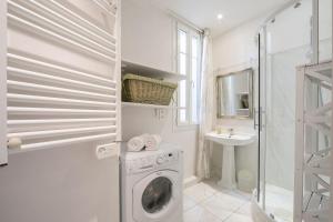 a white laundry room with a washing machine and a sink at Appartement Picasso - Old Town Antibes - Happy Rentals in Antibes