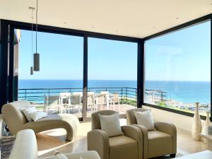 a living room with a view of the ocean at Sitges Spaces Sea View Villa- 6 Bedrooms, 5 bathrooms, 2 private pools, Near center in Sitges