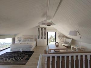 a white bedroom with a bed and a table at Sitges Spaces Sea View Villa- 6 Bedrooms, 5 bathrooms, 2 private pools, Near center in Sitges +86 photos