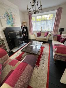 a living room with a couch and a table at Central City Centre 3 bedroom home Private Parking in Plymouth