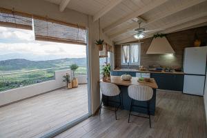 a kitchen with a counter and a large window at Nikola's endless view in Stíronas