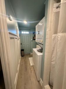 a small laundry room with a washer and dryer at Palm Paradise Retreat in St Petersburg