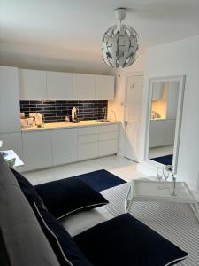 a kitchen with a couch and a table in a room at Jurassic Hideaway in Budleigh Salterton