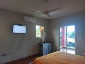 a bedroom with a bed and a flat screen tv at New apartment close to everything in Santiago de los Caballeros