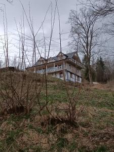 ein großes Haus auf einem Hügel in der Unterkunft Wczasowisko Rudawski Zakątek in Wieściszowice