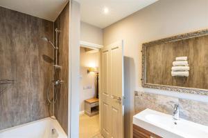 a bathroom with a sink and a shower at The Brantwood Hotel in Penrith
