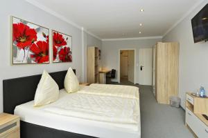 Postel nebo postele na pokoji v ubytování Hotel Haus Kleimann-Reuer