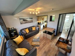 a living room with a couch and a table at 44 Sundowner Hemsby in Great Yarmouth