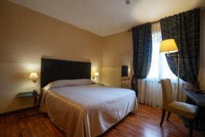 Postel nebo postele na pokoji v ubytování Hotel Bernardino