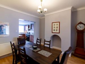 a dining room with a table and a grandfather clock at Church View - Pass the Keys in Ferryhill