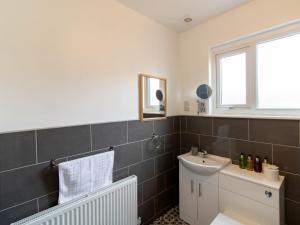 a bathroom with a sink and a mirror at Church View - Pass the Keys in Ferryhill +32 photos