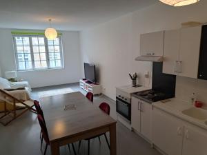 a kitchen with a table and a dining room at Appartement proche centre ville et sur les remparts in Langres