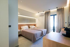 a hotel room with a bed and a television at Arocaria Apartments in Chania Town