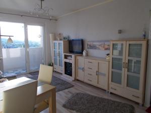 a living room with a television and a dining table at Apartament SUNNY in Gdynia
