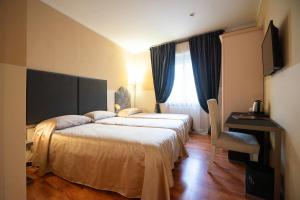 Postel nebo postele na pokoji v ubytování Hotel Bernardino