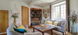 a living room with a couch and a table at La Source in Saint-Cybranet