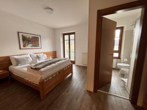 a bedroom with a large bed and a bathroom at Hotel Lido in Ledro