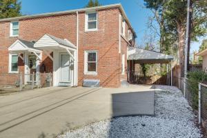 a brick house with a driveway in front of it at Updated Arlington Townhome about 5 Mi to National Mall in Arlington