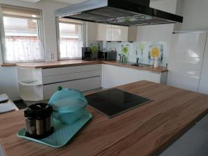 a kitchen with a wooden table with a bowl on a counter at Fewo Halbe Tanne in Schonach