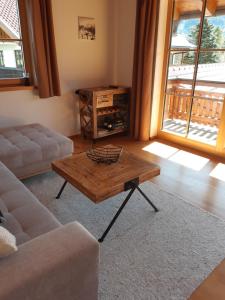 a living room with a coffee table and a couch at Haus Sunnawind in Wallgau