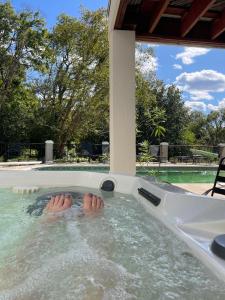 a persons feet in a jacuzzi in a swimming pool at The Lakehouse in Hendersonville