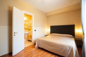 Postel nebo postele na pokoji v ubytování Hotel Bernardino