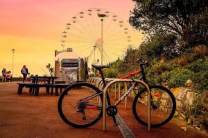 a bike parked in front of a ferris wheel at Seaside Serenity Modern Apartment Close To Beach in Eastbourne