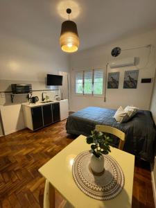 a bedroom with a bed and a table and a kitchen at Ana Rent lll in Boulogne
