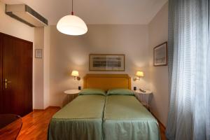 Postel nebo postele na pokoji v ubytování Hotel Bernardino