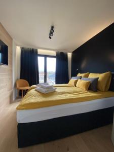 a bedroom with a large bed with a large window at Chambres4you in Namur