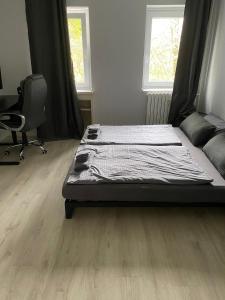 a bedroom with a bed and a desk and a chair at Cozy 2 Rooms Apartment in Bochum