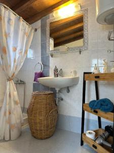 a bathroom with a sink and a mirror at Amalia beach apartment in Kokkari