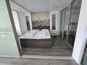 a bedroom with a bed and a view of a city at Luxurious Apartment in Mainz in Mainz
