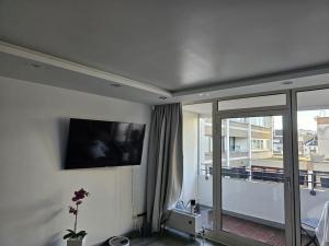 a living room with a flat screen tv on the wall at Luxurious Apartment in Mainz in Mainz