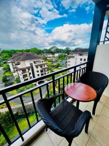 a balcony with two chairs and a table at Tagaytay Staycation - Kasa Luntian in Tagaytay