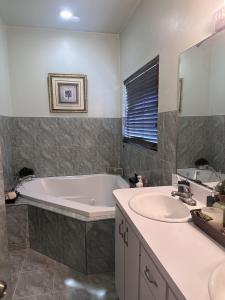a bathroom with a tub and a sink at Quiet Haven in Freeport