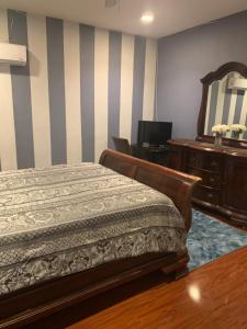 a bedroom with a bed and a dresser and a mirror at Quiet Haven in Freeport