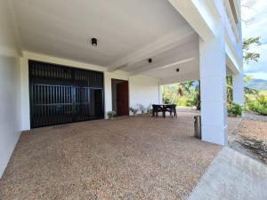 a patio with a black door and a table at Azure Ocean View Villa in Puerto Galera