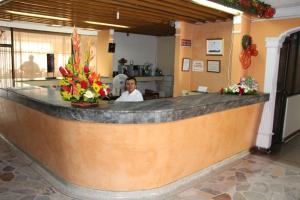 um homem sentado num bar num restaurante em HOTEL DINASTIA REAL NEIVA em Neiva