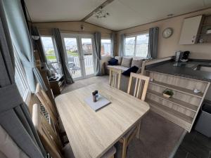 an aerial view of a kitchen and a dining table in an rv at The Pastures Holiday Lodge in Tattershall