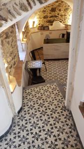 a view of a room with a bed and a tiled floor at A Burgâ du Muntin in Spotorno