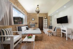 a living room with a bed and a couch at Evi's Afandou Suite in Afantou