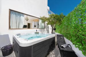 a jacuzzi tub in the backyard of a house at Evi's Afandou Suite in Afantou
