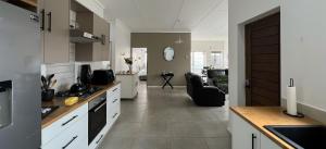 a kitchen with a living room and a dining room at Boschkloof Bliss in George